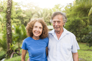 Portrait of a beautiful elderly couple standing embracing outdoors