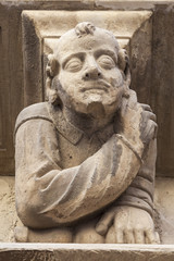 Ancient corbel, located under balconies of city hall, represent different aspects of characters medieval era, Cervera, province Lleida, Catalonia.Spain.