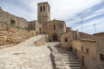  Village street view, ancient buildings and church, medieval village of Guimera, Province Lleida, Catalonia, Spain.
