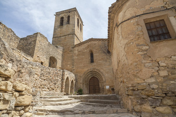 Fototapeta na wymiar Old street view, ancient buildings and church, medieval village of Guimera, Province Lleida, Catalonia, Spain.