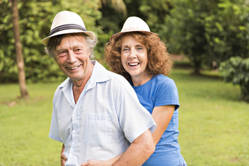 Portrait of a beautiful elderly couple standing embracing outdoors