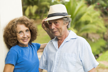 Portrait of a beautiful elderly couple standing embracing outdoors