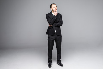 Thoughtful young business man looking isolated on white background