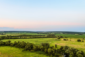 View of green forest-steppe plain. Flatland valley in evening time. Belgorod region, Russia.