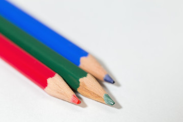 three colored pencils in the colors red green blue