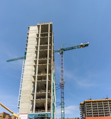Naklejka premium new building construction of a modern multi-storey building with a tower crane