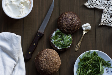 Cottage cheese. Cheese cream on rye bread. Health food. Vegetarian sandwich with rocket salad. Idea for healthy breakfast. Rustic breakfast. Countryside snack.