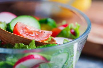 Close-up of summer fresh vegetable salad in kitchen. The concept of the vegetarian and healthy food.