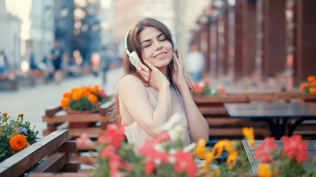 Smiling young girl listen to music on headphones