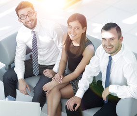 friendly business team sitting in office lobby