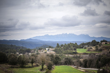  Landscape view, cloudy day, Montserrat mountain at background in village of Calders, Moianes region comarca, province Barcelona, Catalonia.