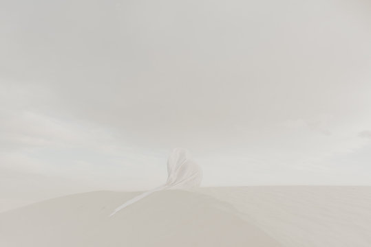 White on white concept with a white flow fabric hiding a human silhouette