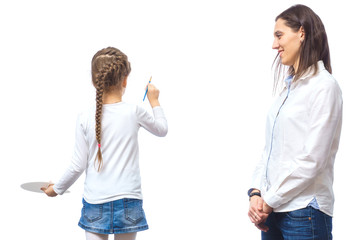 Family creativity. A little girl paints with watercolors.