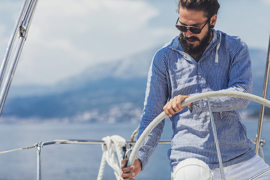 Skipper Holding Sailboat Helm