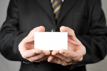 Businessman holding a business card. Mock up. Copy space.