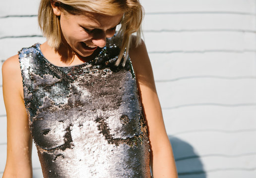 Woman in a sequin dress with breasts drawn on it