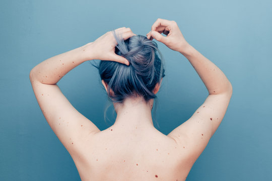 Delicate Young Woman With Pale Skin and Blue Dyed Hair