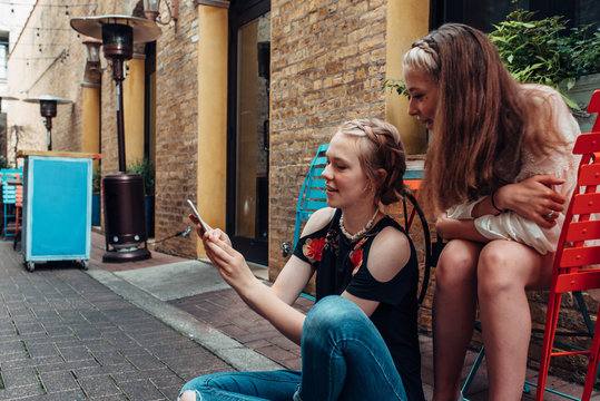Two teenage girls checking a smartphone