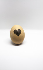 heart written on the egg on the light background