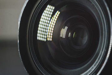 Photo Camera or Video lens close-up on black background, objective, concept of photographer camera man job, looking for a photographer, journalist, a videographer to work