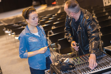 male and female sound engineers setting up before the gig