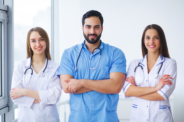 Portrait of group of smiling hospital colleagues standing together