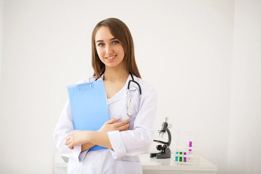 Portrait of young doctor standing in medical office