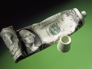 deflation economy reserve currency US dollar wrapped on toothpaste tube