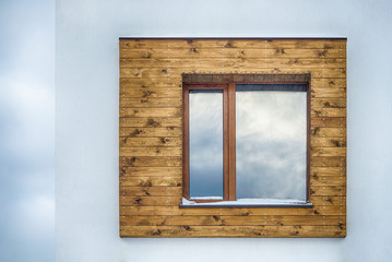 Window on a wall lined with wood