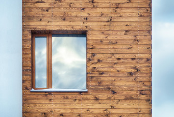 Window on a wall lined with wood