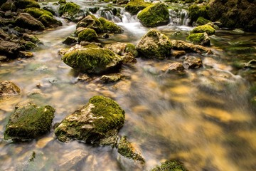 Fototapeta na wymiar Mountain river with cascade and huge rocks