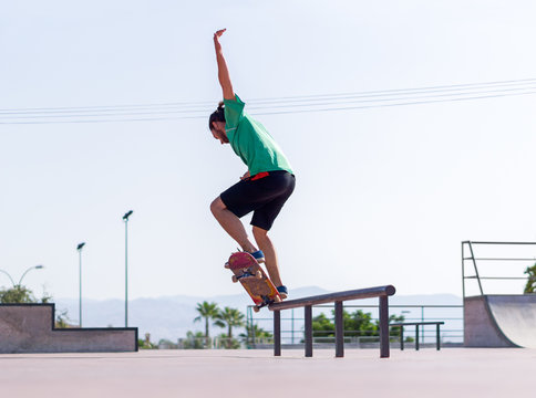 Young balancing on a skateboard in skate park