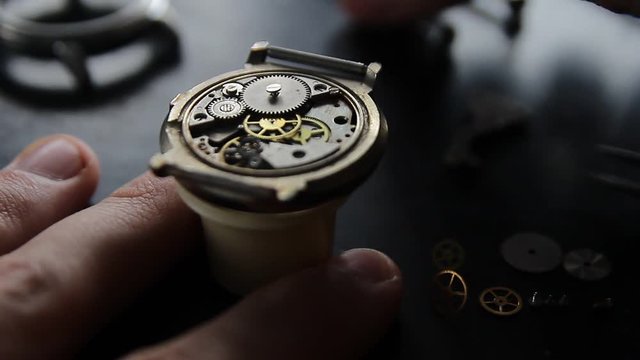 Watchmaker is repairing the mechanical watches in his workshop