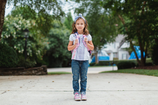 Portrait of a cute young girl wearing a backpack