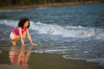 Fototapeta premium Young mixed race woman on the sea beach.
