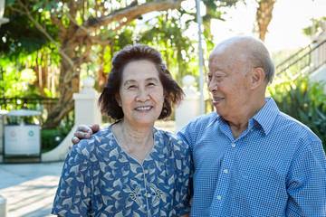 Happy Senior Asian Couple in a Park