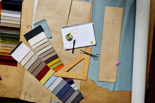 Fabric Swatches And Work Tools On Workbench At Sofa Workshop
