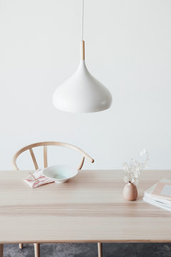 Handmade ceramics on wooden table and white lamp