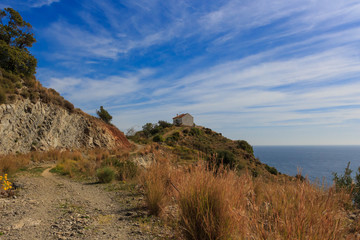 Alone house is situated on the cliff almost near the clouds. 