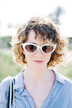 Curly woman in sunglasses