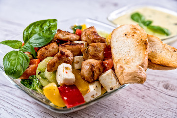 salad, Greek, Italian, tomato mozzarella Basil leaves, peppercorn and olive oil on a wooden table. Recipe - Composition