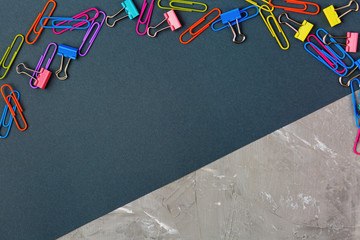 colored paperclips on a black and gray background