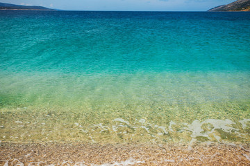 Fototapeta na wymiar Sea water clean and transparent with gradient of blue, turquoise and gold colors