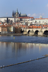 Fototapeta na wymiar Early Spring Prague gothic Castle and Charles Bridge with the Lesser Town in the sunny Day, Czech Republic