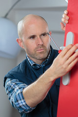 man fixing the door with screwdriver