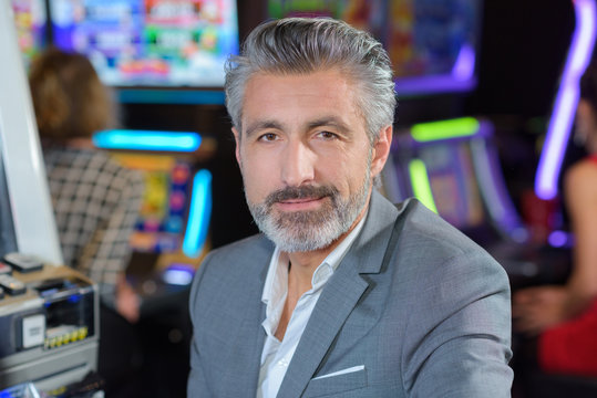 handsome man with slot machine in the casino