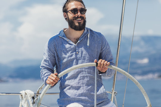 Skipper Holding Sailboat Helm