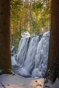 Fototapeta Wild waterfall in winter