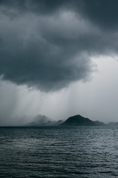 Storm over island in ocean