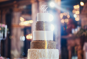 White wedding cake decorated with crystals and glaze bow